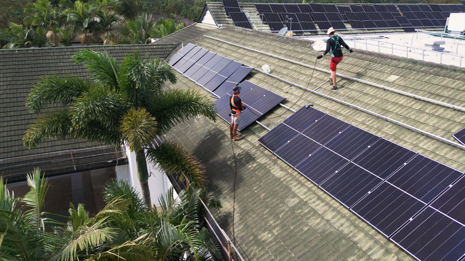 Mercure Gold Coast Resort, Solar Panel Installation. Solar Panels install. Gold Coast Electricians installing solar panels to business roof. View from room of building, looking out to the project installation work in progress.