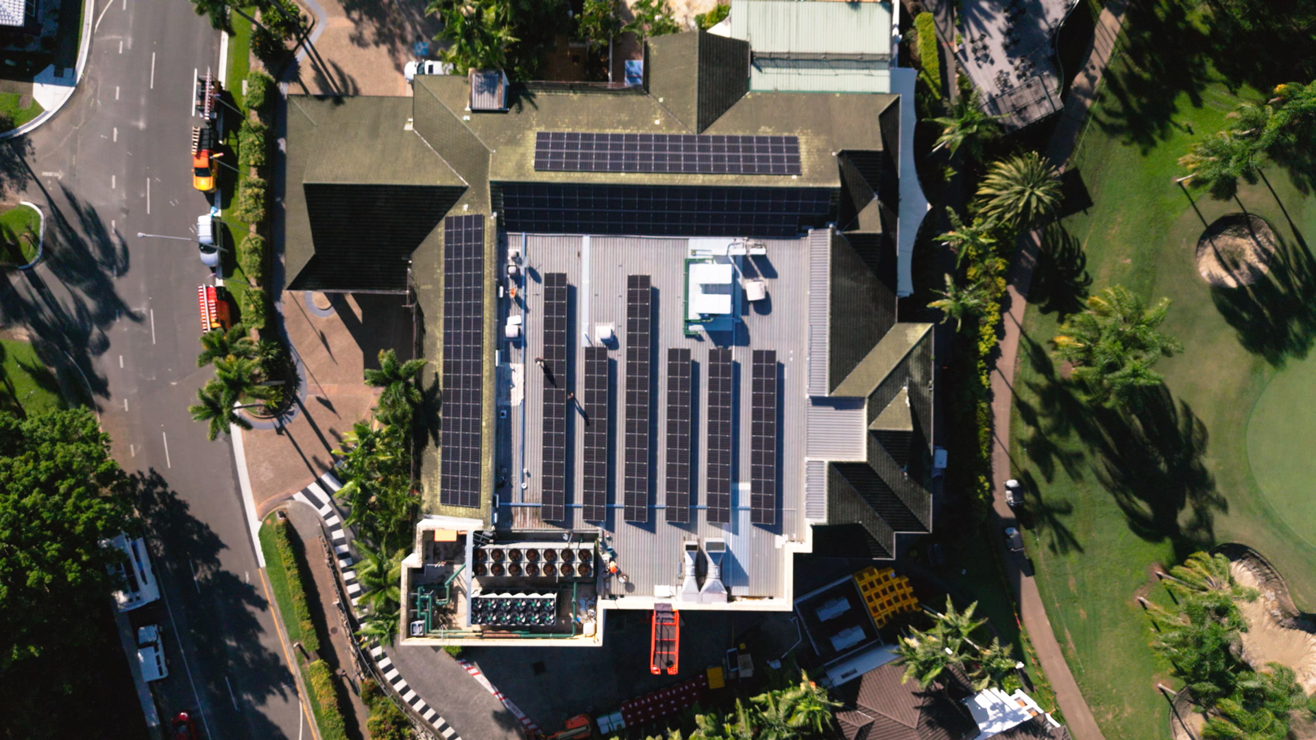 Mercure Gold Coast Resort, Solar Panel Installation. Solar Panels install completed. Top view. Birds-eye view of professional, quality solar installation. Gold Coast Electricians installing solar panels to business roof. View from room of building, looking at hotel.