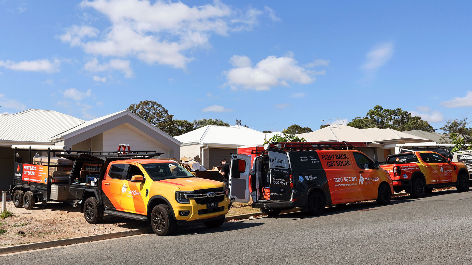 Meridien Energy work vehicles outside the Oremau residential work site. Solar Power System installed on an Ormeau house roof. 18x Astronergy N7s 440W Bifacial Solar Panels. 7.92kW Solar System. 29.4kWh Solax Battery. Long duration emergency backup storage.