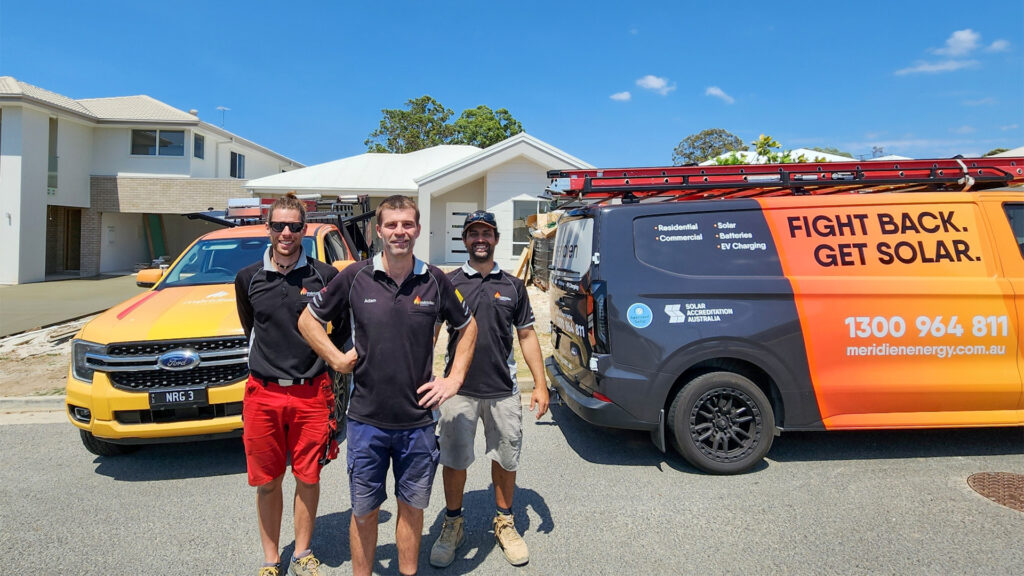 Three Meridien Energy Solar Installation team members, with Senior Electrician. Solar Power System installed on an Ormeau house roof. 18x Astronergy N7s 440W Bifacial Solar Panels. 7.92kW Solar System. 29.4kWh Solax Battery. Long duration emergency backup storage.
